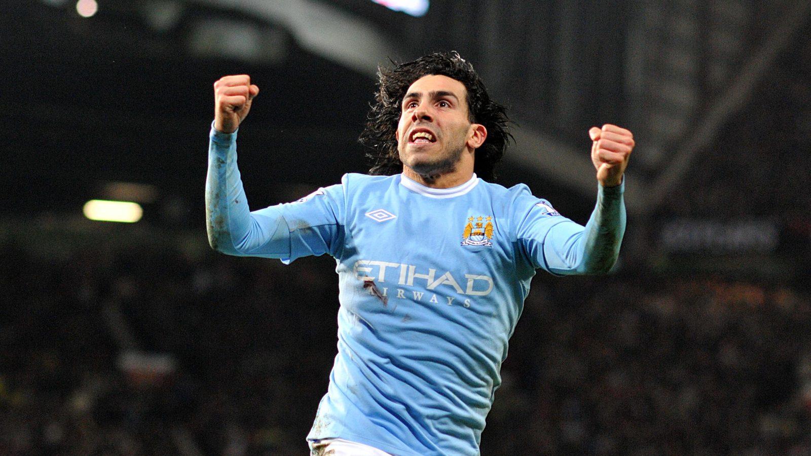 Carlos Tevez celebrates for Manchester City at Old Trafford.