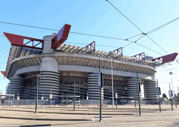 Khán đài San Siro bùng cháy với pháo sáng và cờ AC Milan trong ngày thi đấu.