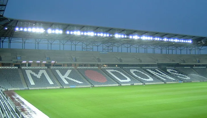 Khán đài với hàng chữ "MK DONS" màu trắng nổi bật, thể hiện niềm tự hào của câu lạc bộ