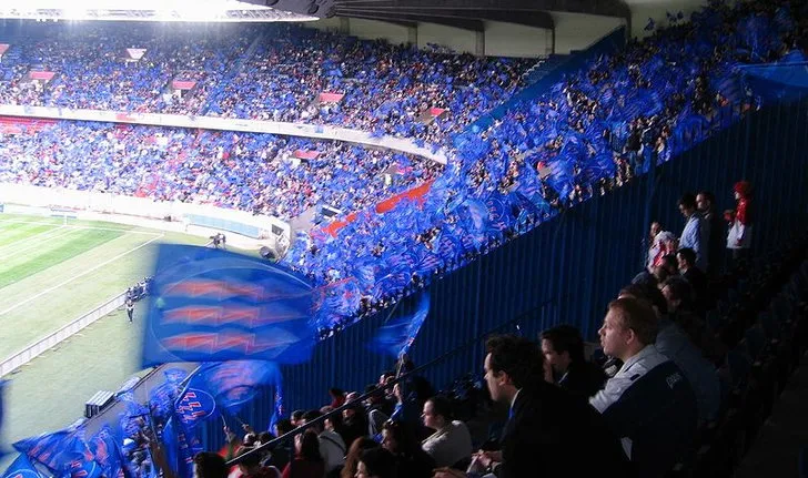Một góc khán đài chi tiết tại Parc des Princes, nổi bật với hàng ghế màu xanh đỏ đặc trưng của Paris Saint-Germain.